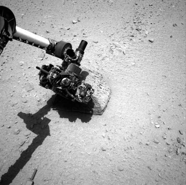 This NASA handout image shows the robotic arm of the Mars rover Curiosity with the first rock touched by the Alpha Particle X-Ray Spectrometer